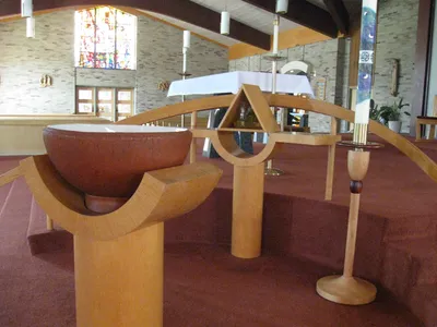 Baptismal font and ambry next to sanctuary.