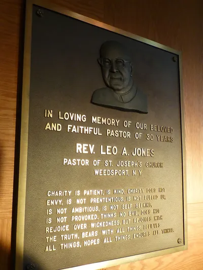 Memorial plaque to former pastor.