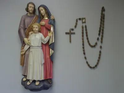 Wall-mounted statue of the holy family.