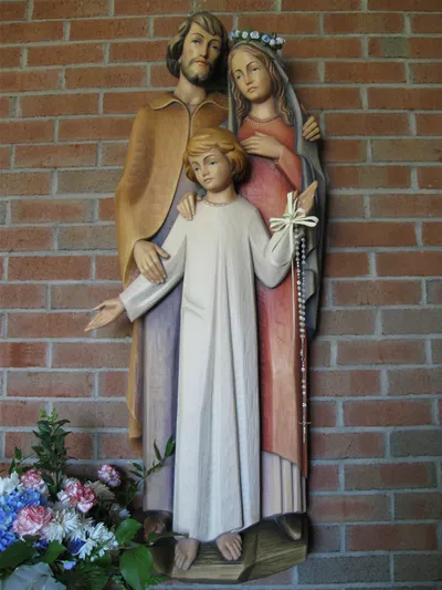 Wall-mounted holy family statue.