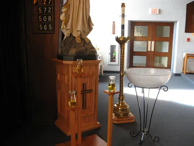 Chrisms, Baptismal font, and paschal candle.