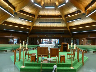 From behind the sanctuary.