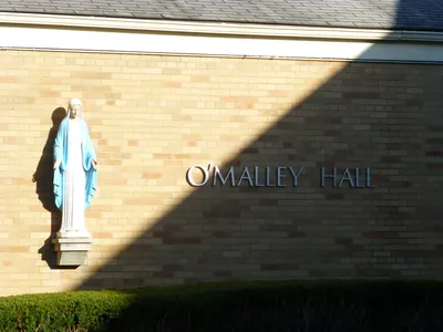 Sign outside parish hall and statue of Our Lady.