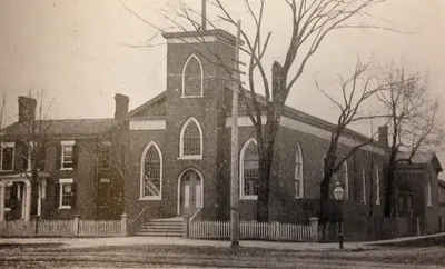 Exterior of former church. Source: Parish history book (1919)