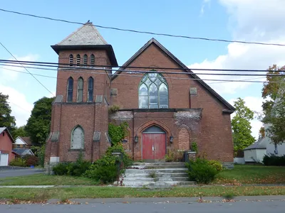 Exterior. Most of the stained glass has been removed save for the windows above the main entrance.