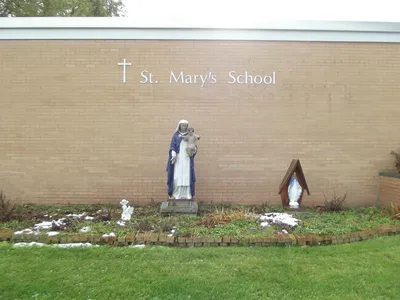 Statues and garden area outside school.