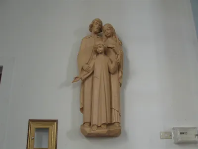 Wall-mounted holy family statue.