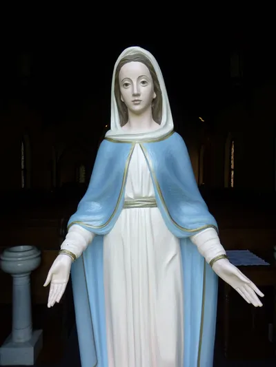 Statue of Our Lady in front window.