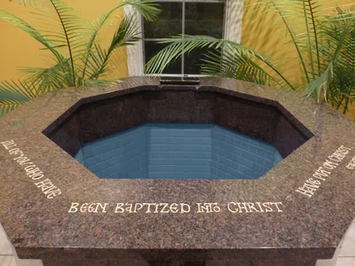 Inscription atop baptismal font.