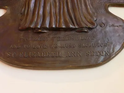 Inscription at base of the relief.