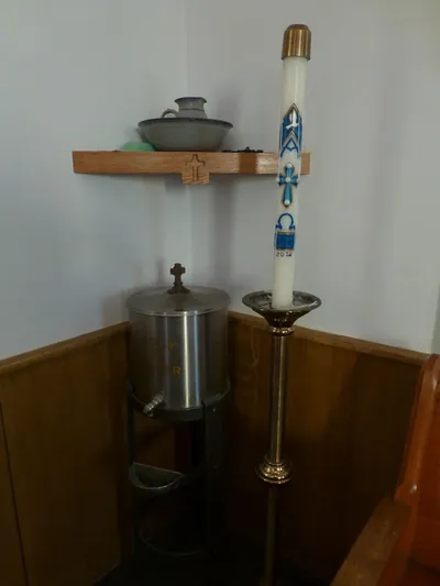 Holy water font and paschal candle.