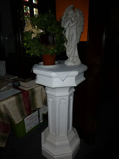 Angel statue on pedestal.