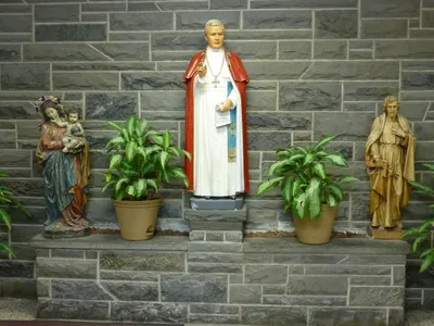 Statues of Our Lady, St. Pius X, and St. Joseph in the school.