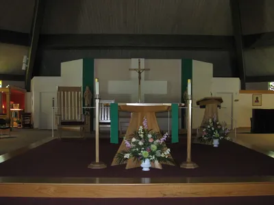 Interior, Sep. 2009. Statues flank the cross behind altar.