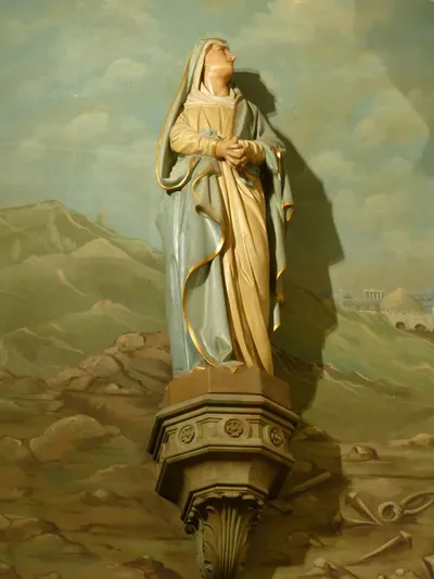 Statue on sanctuary wall.