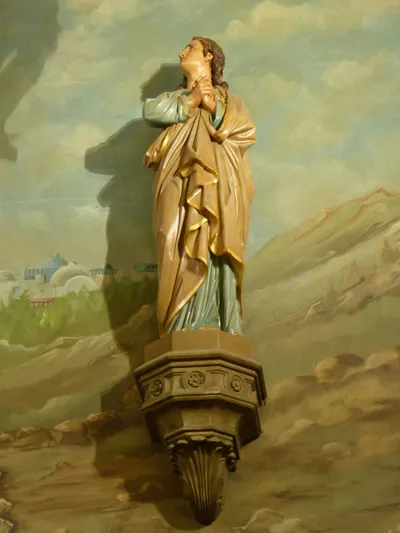 Statue on sanctuary wall.