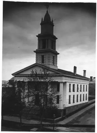 Exterior of first church as former Dutch Reformed Church used from 1904-1912, corner of S. Main and William St. The building still exists, but without the steeple and a tad enlongated. Source: New York Heritage