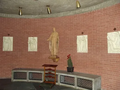 Stations of the cross and sacred heart statue.