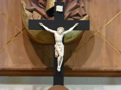 Crucifix atop altar.