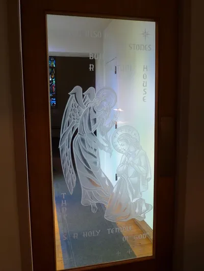 Sandblasted artwork on entrance to chapel.