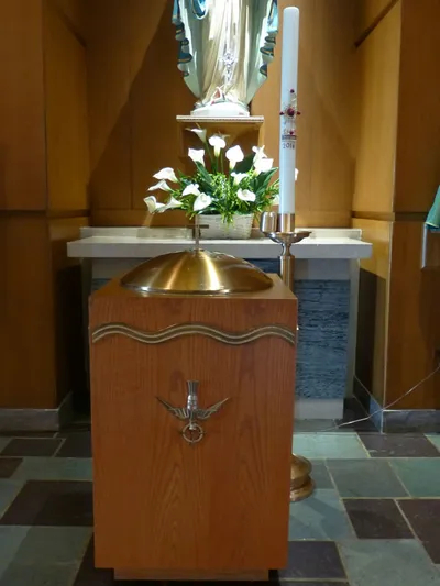 Baptismal font in front of right side altar.