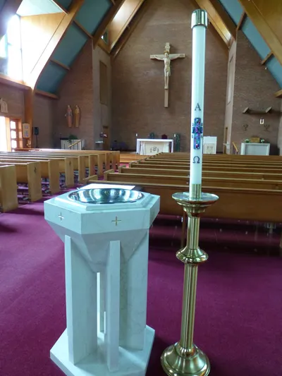 Baptismal font and paschal candle.