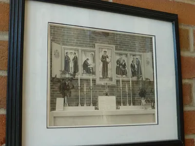 Photograph of the high altar with St. Thomas More paintings. These paintings are now in the gathering space to the left of the church.